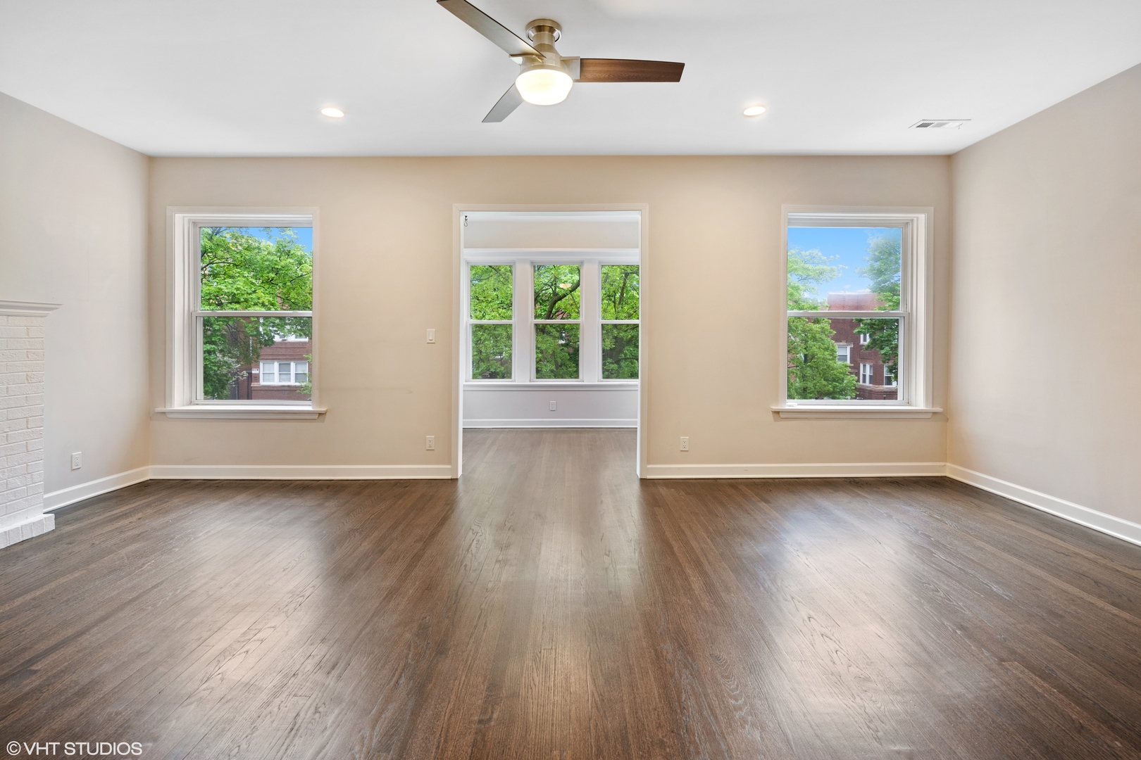 4944 North Drake Avenue, Unit 2 Chicago, IL 60625 - Photo 4 of 13 an empty room with wooden floor and windows