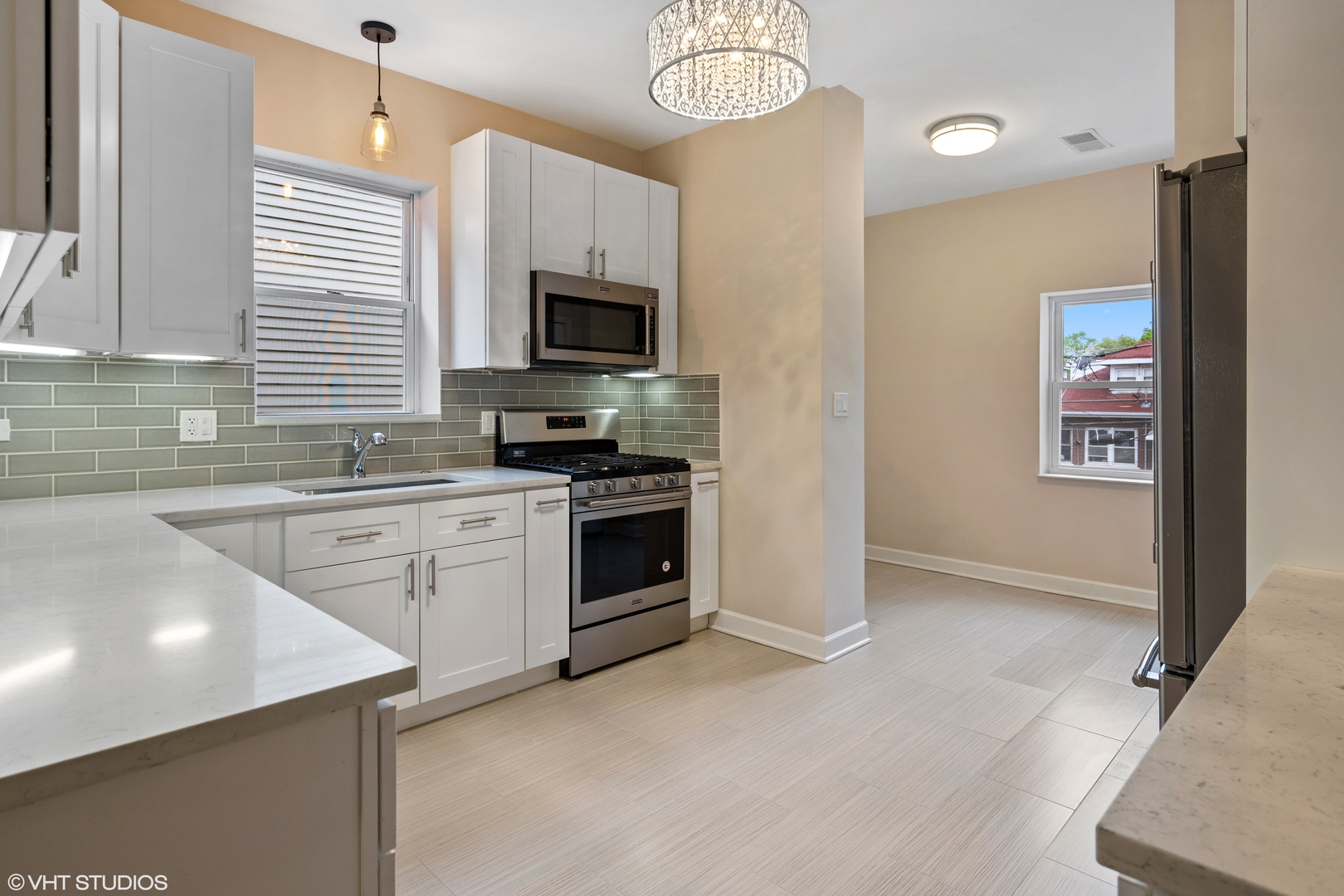 4944 North Drake Avenue, Unit 2 Chicago, IL 60625 - Photo 5 of 13 a kitchen with cabinets stainless steel appliances and a window