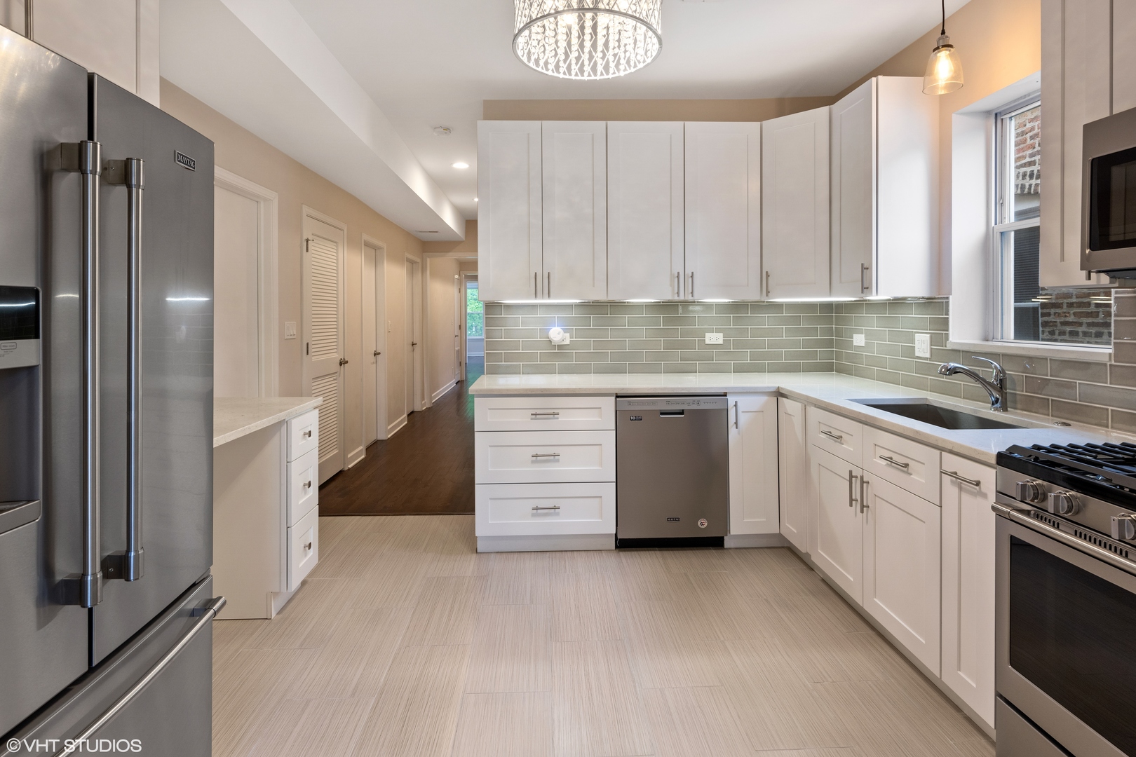 4944 North Drake Avenue, Unit 2 Chicago, IL 60625 - Photo 7 of 13 a kitchen with white cabinets and white appliances