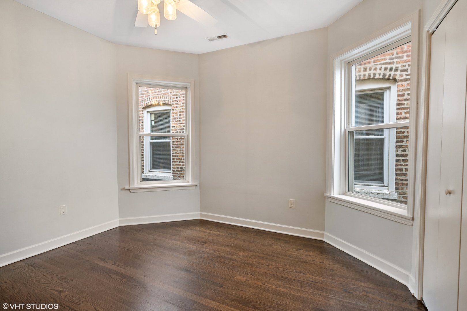 4944 North Drake Avenue, Unit 2 Chicago, IL 60625 - Photo 8 of 13 an empty room with wooden floor and windows