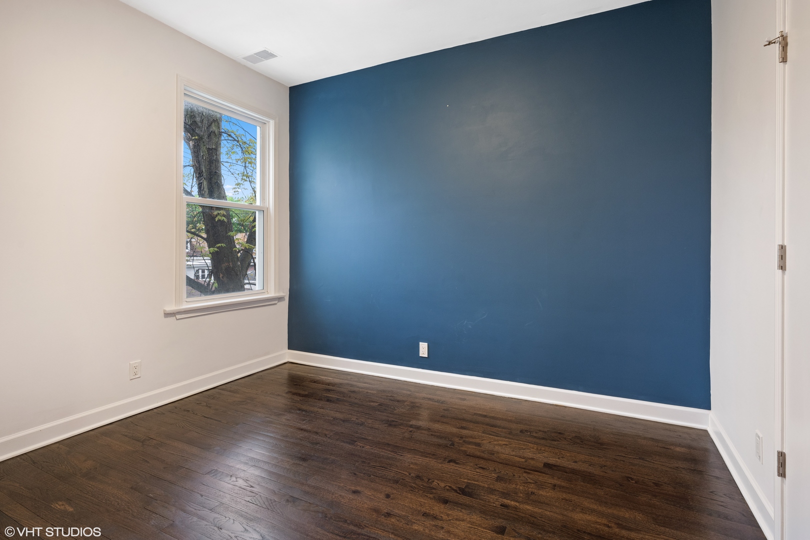 4944 North Drake Avenue, Unit 2 Chicago, IL 60625 - Photo 9 of 13 a view of an empty room with wooden floor and a window