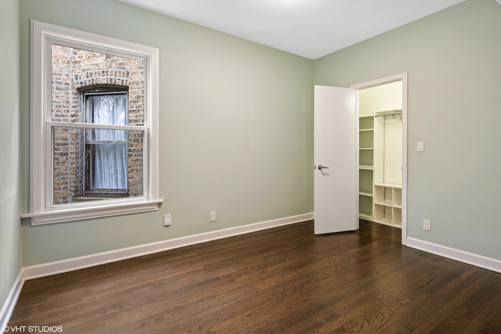 4944 North Drake Avenue, Unit 2 Chicago, IL 60625 - Photo 10 of 13 a view of an empty room with wooden floor and a window