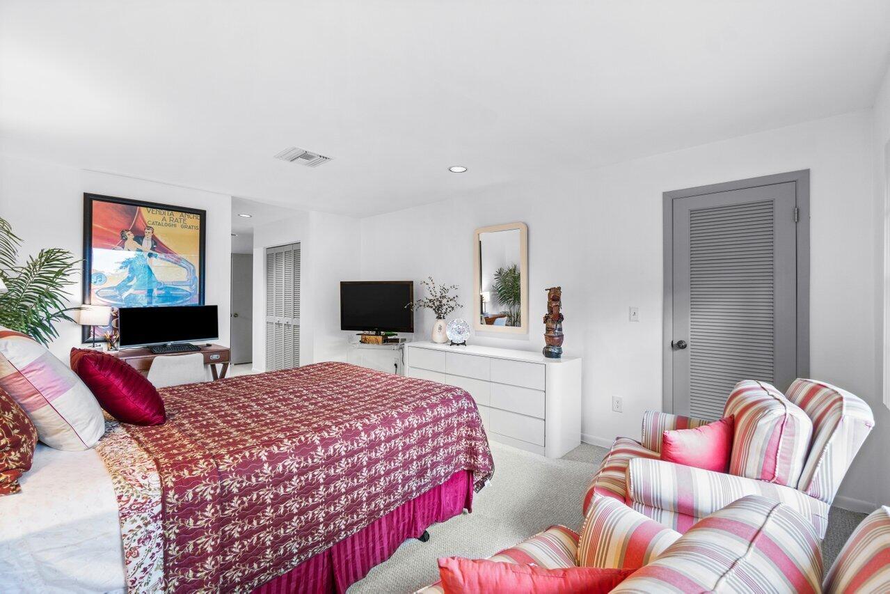 20 Westgate Lane, Unit B Boynton Beach, FL 33436 - Photo 11 of 46 a bedroom with a bed and flat screen tv