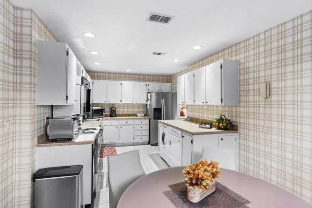 a kitchen with a sink cabinets and window