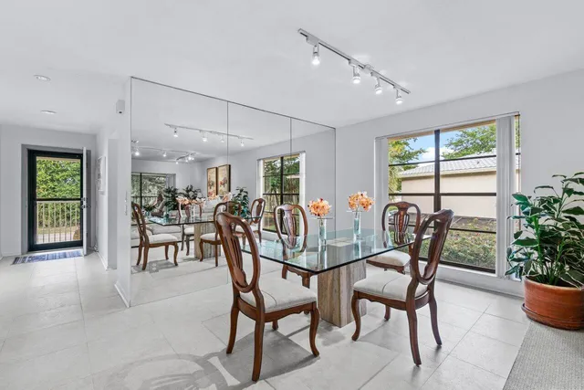 a view of a dining room and livingroom with furniture window and wooden floor