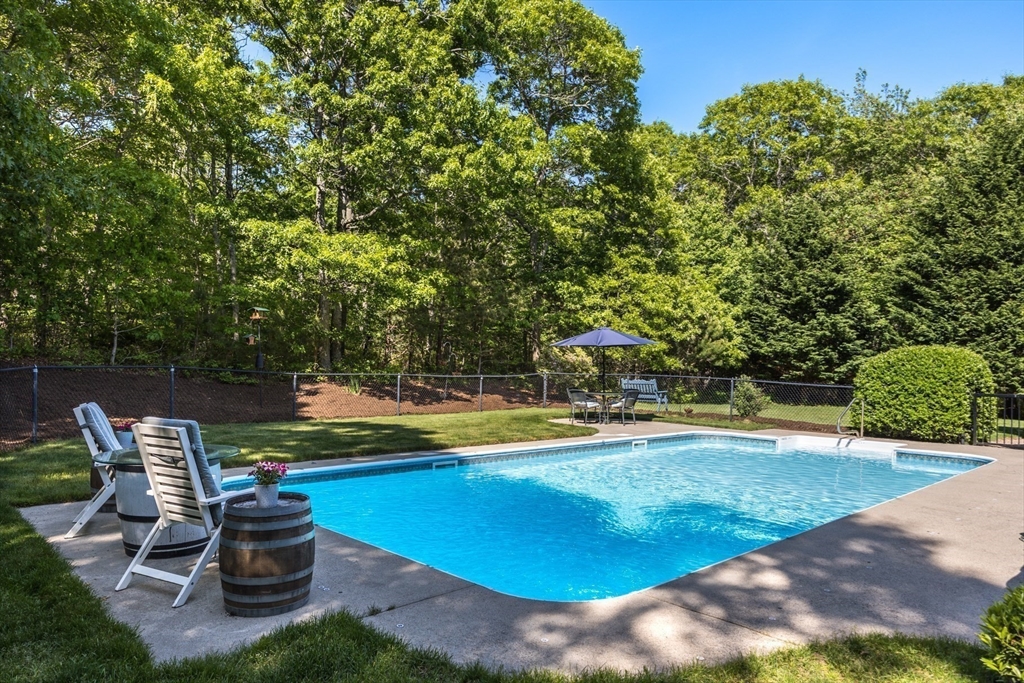 141 Cairn Ridge Road East Falmouth, MA 02536 - Photo 3 of 42 a swimming pool with outdoor seating and yard