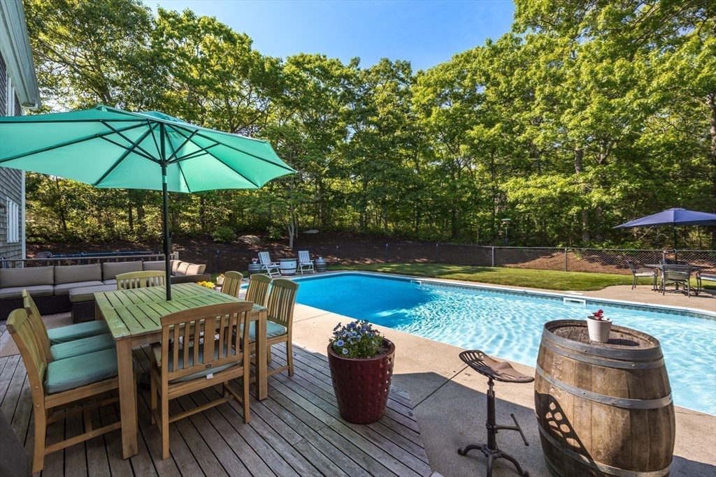 141 Cairn Ridge Road East Falmouth, MA 02536 - Photo 34 of 42 a view of a swimming pool and patio from a patio
