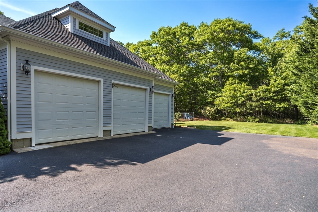 141 Cairn Ridge Road East Falmouth, MA 02536 - Photo 38 of 42 a view of a house with a yard and garage