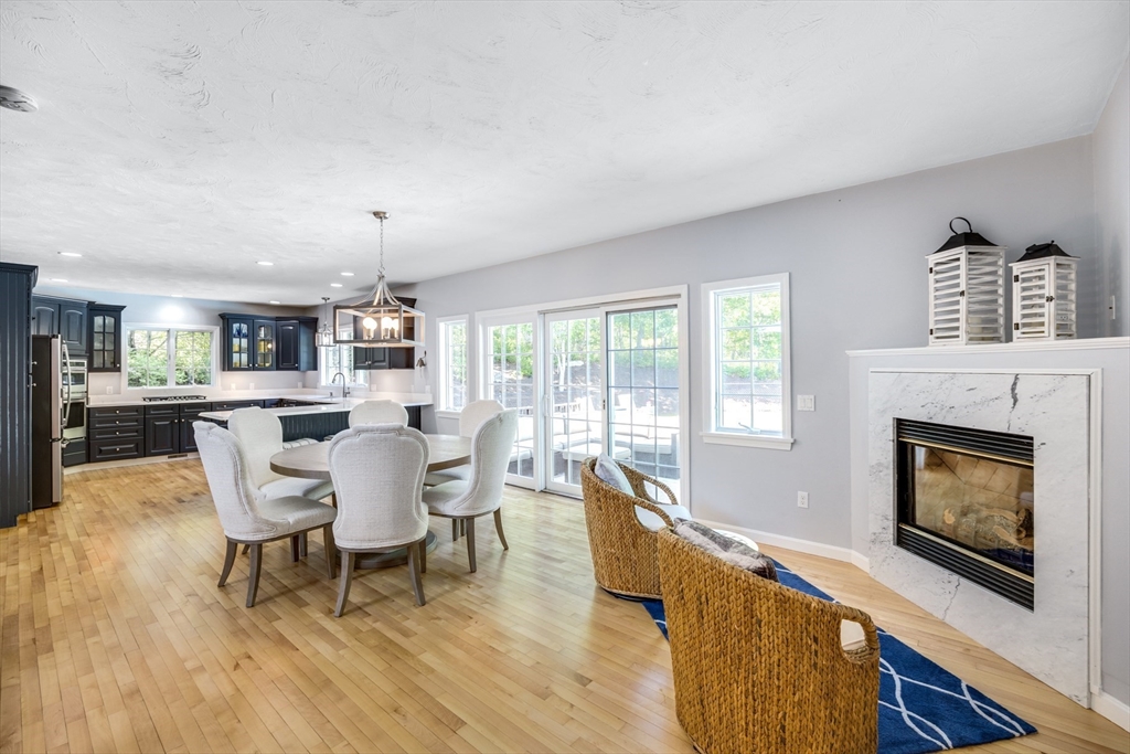 141 Cairn Ridge Road East Falmouth, MA 02536 - Photo 6 of 42 a living room with furniture a fireplace and a floor to ceiling window