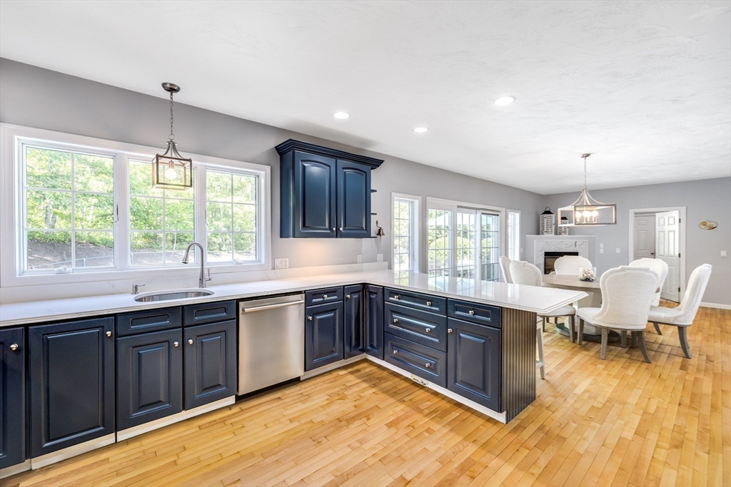 141 Cairn Ridge Road East Falmouth, MA 02536 - Photo 8 of 42 a kitchen with a sink and wooden cabinets