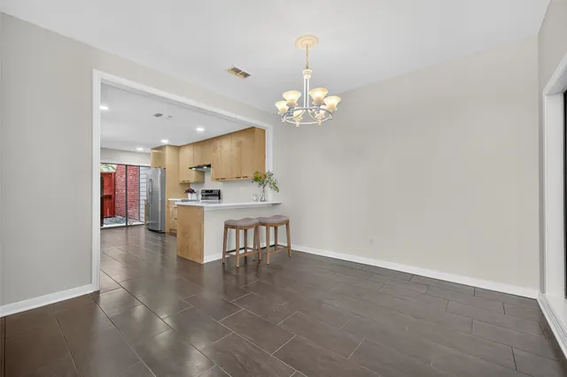 a kitchen with stainless steel appliances granite countertop a sink a stove and cabinets