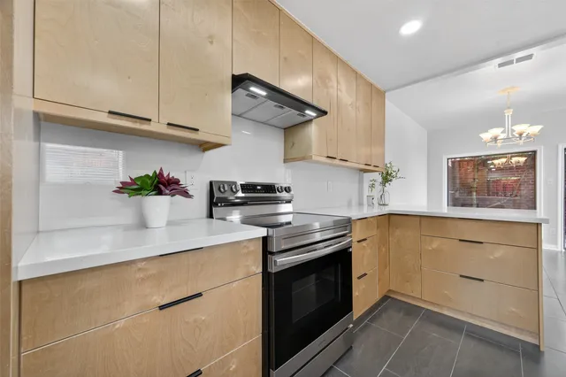 a large kitchen with stainless steel appliances kitchen island granite countertop a large counter top a sink stainless steel appliances and cabinets