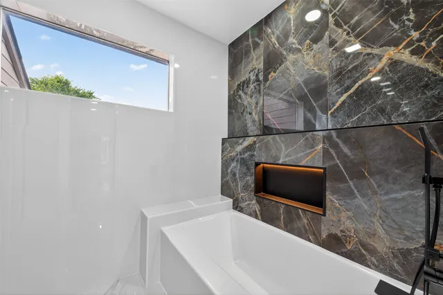 a bathroom with a shower and a mirror