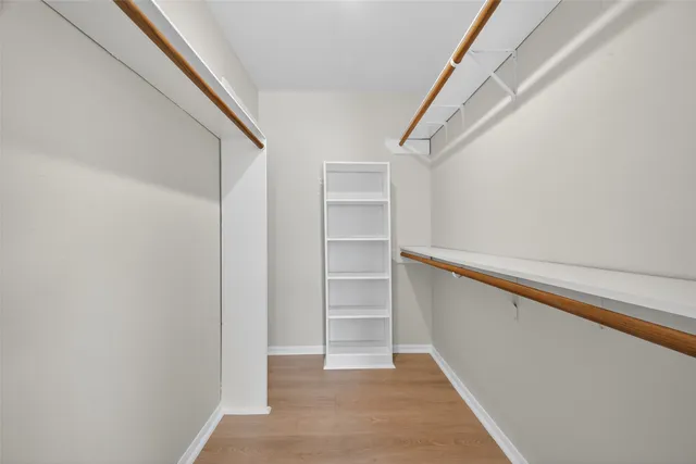 an empty room with windows and closet