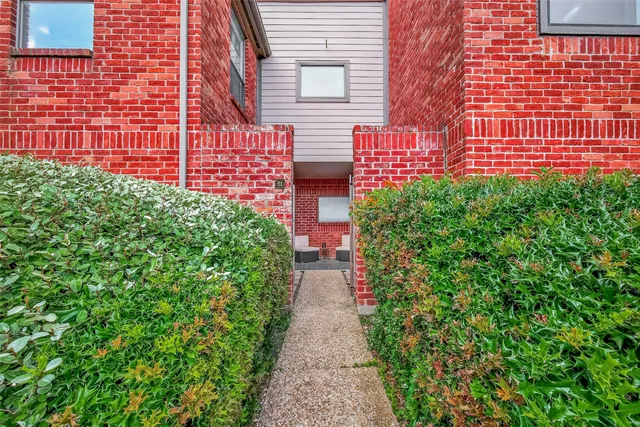 a view of a pathway with a house in the background