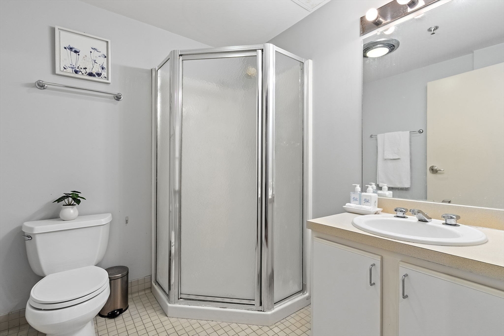 534 Commonwealth Avenue, Unit 3A Boston, MA 02215 - Photo 11 of 18 a bathroom with a toilet a sink and a mirror