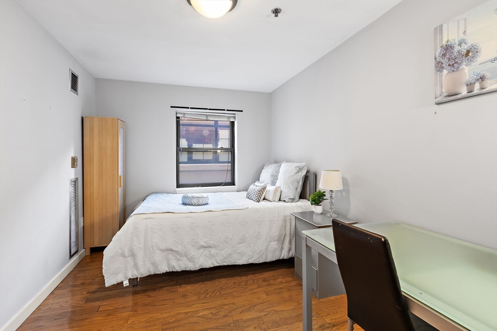 534 Commonwealth Avenue, Unit 3A Boston, MA 02215 - Photo 7 of 18 a bedroom with a bed and wooden floor