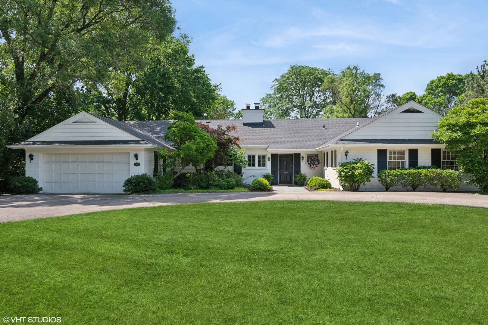 a front view of a house with a garden and porch