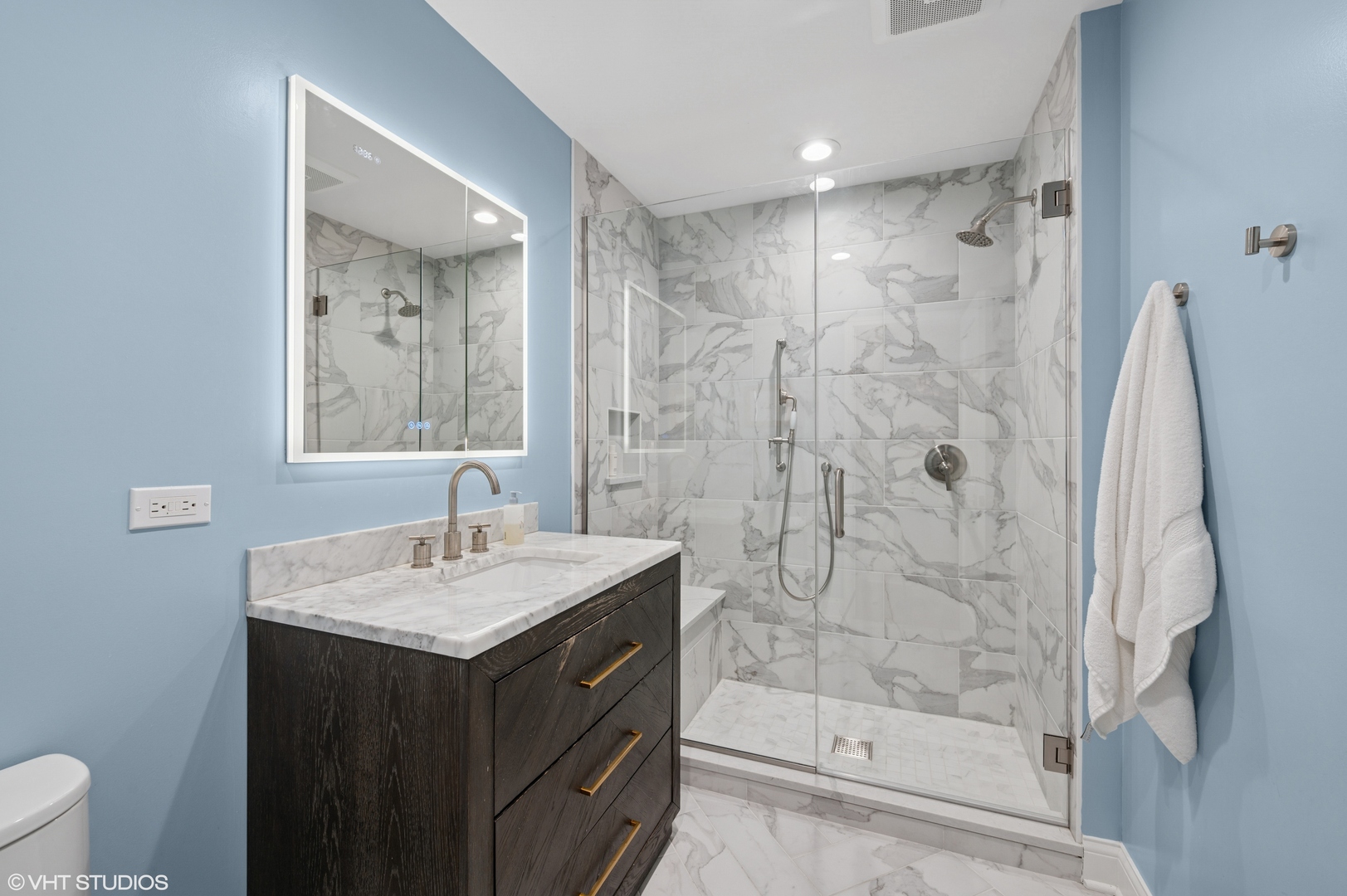 1560 Tower Road Winnetka, IL 60093 - Photo 20 of 27 a bathroom with a sink vanity granite shower and a mirror