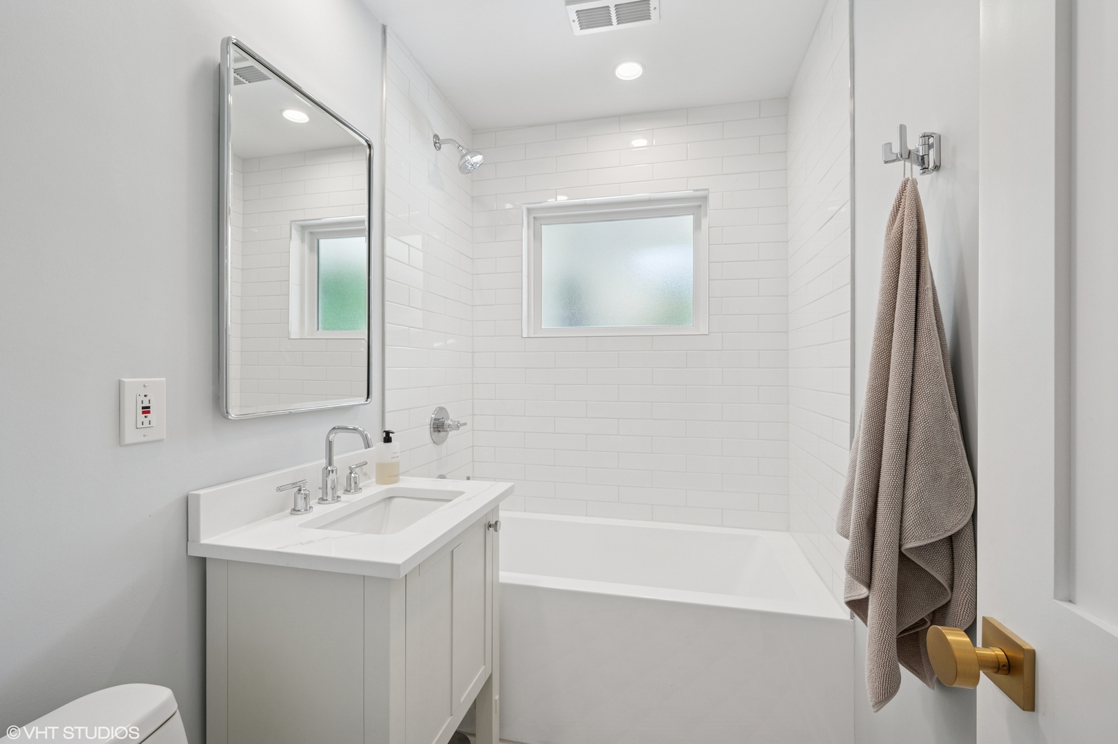 1560 Tower Road Winnetka, IL 60093 - Photo 22 of 27 a bathroom with a sink a toilet and a mirror