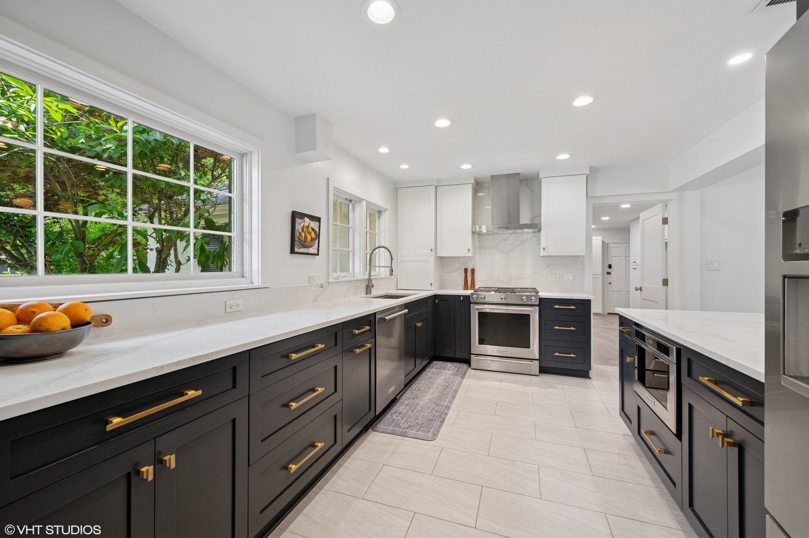 1560 Tower Road Winnetka, IL 60093 - Photo 7 of 27 a large kitchen with stainless steel appliances granite countertop a large counter top a stove and a sink