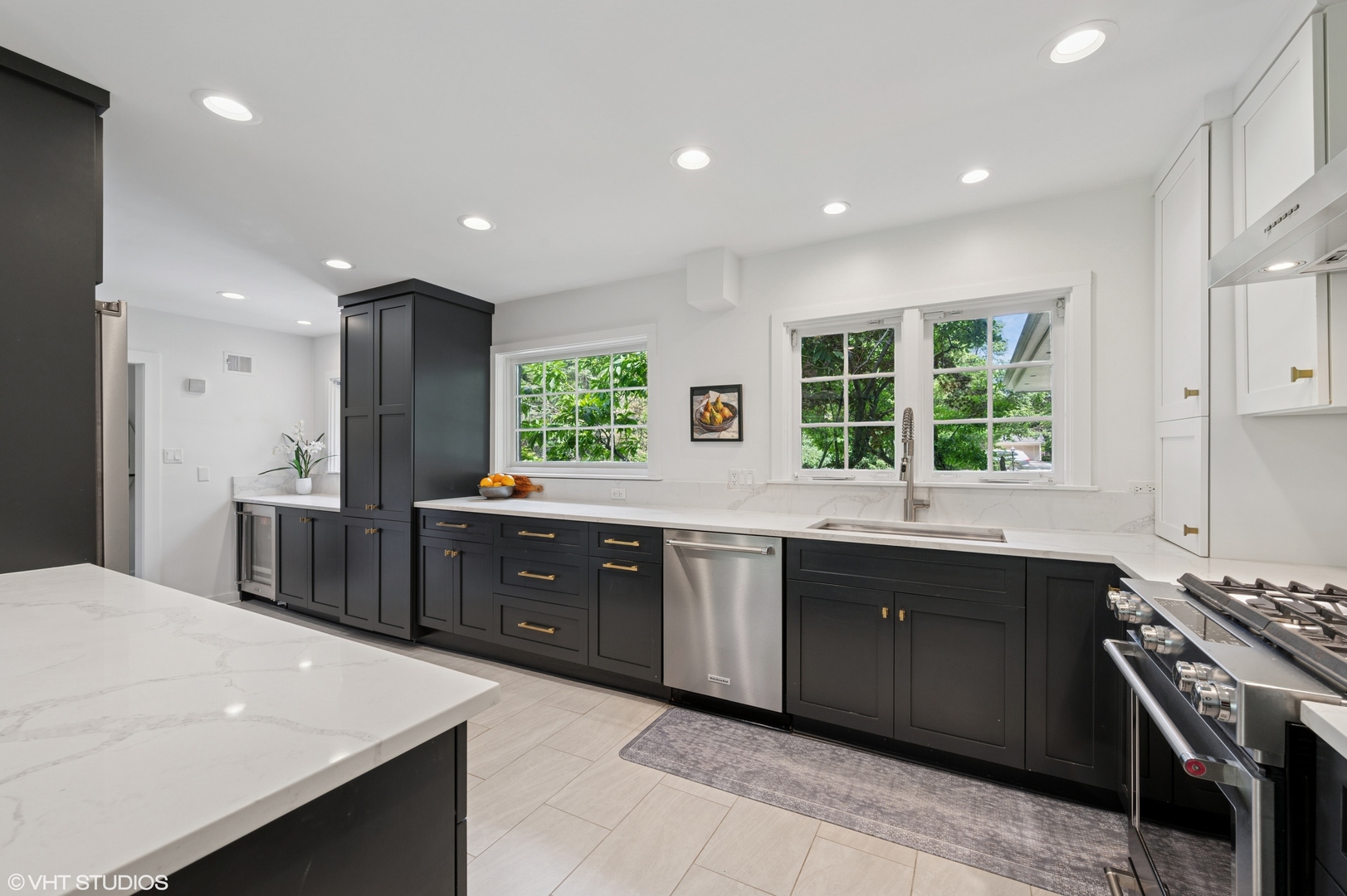 1560 Tower Road Winnetka, IL 60093 - Photo 8 of 27 a large kitchen with stainless steel appliances a sink dishwasher a stove and a refrigerator with wooden cabinets