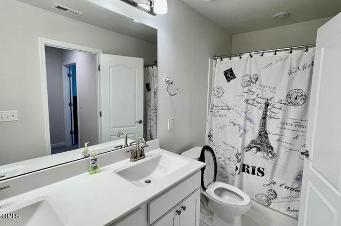 1807 Wrenn Road Durham, NC 27703 - Photo 31 of 43 a bathroom with a sink and a mirror