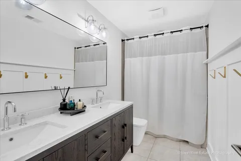 a bathroom with a double vanity sink and a mirror