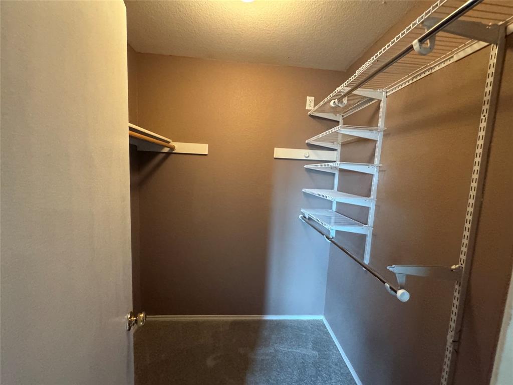 3200 Crownover Street Austin, TX 78725 - Photo 16 of 23 Ample shelving and hanging space make organization effortless in this practical walk-in closet.