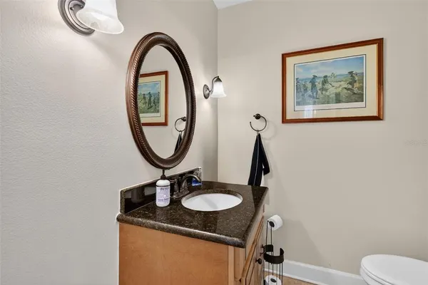 a kitchen with granite countertop a refrigerator stove and sink
