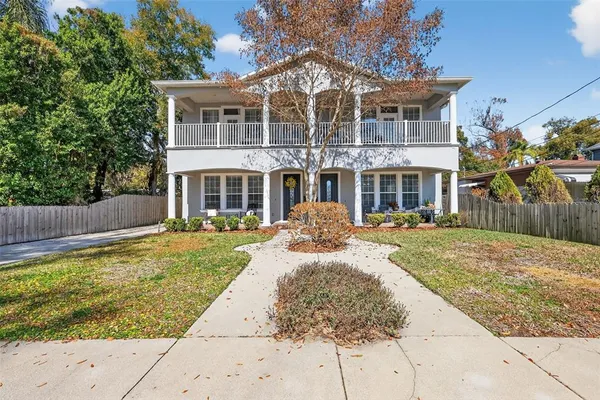 a front view of a house with a garden and plants