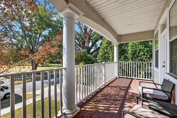 a living room with stainless steel appliances kitchen island granite countertop furniture and a large window