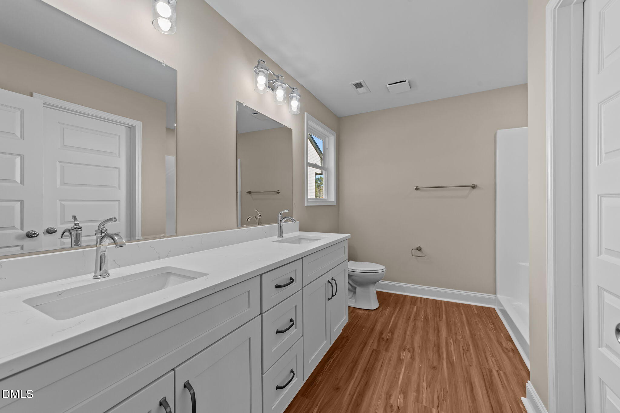 108 Wichita Way Louisburg, NC 27549 - Photo 11 of 55 a spacious bathroom with a double vanity sink a mirror and a toilet
