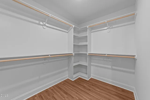 a view of walk in closet with empty racks