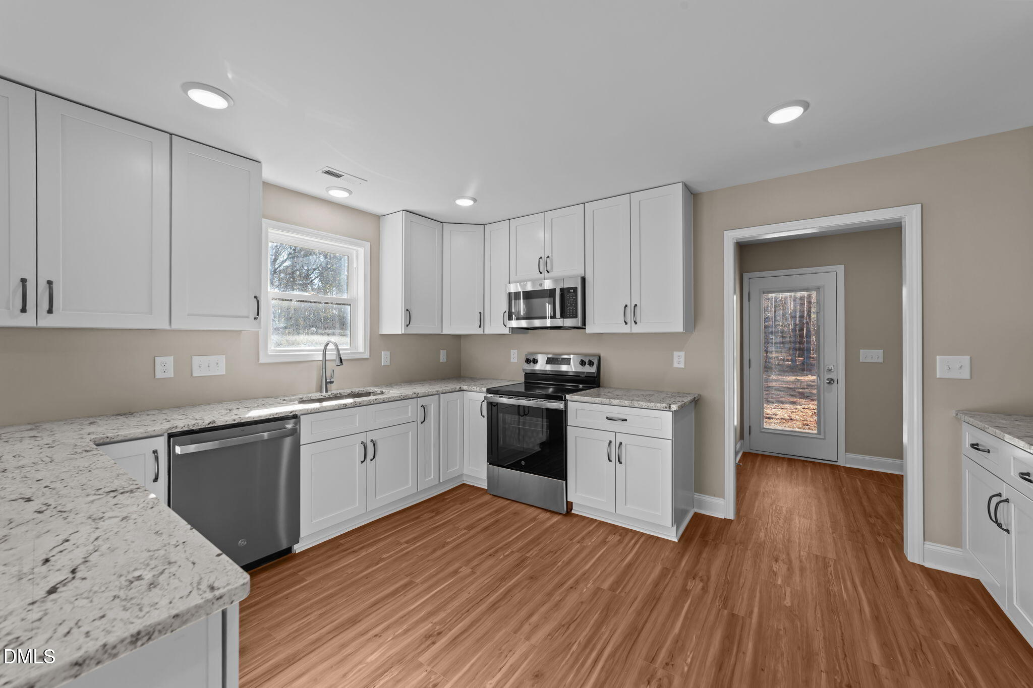 108 Wichita Way Louisburg, NC 27549 - Photo 3 of 55 a kitchen with wooden floors and white appliances