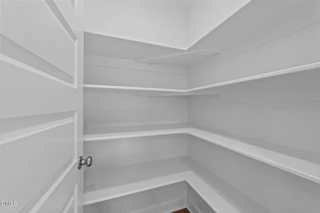 a kitchen with stainless steel appliances granite countertop a stove top oven a sink dishwasher and a refrigerator with wooden floor