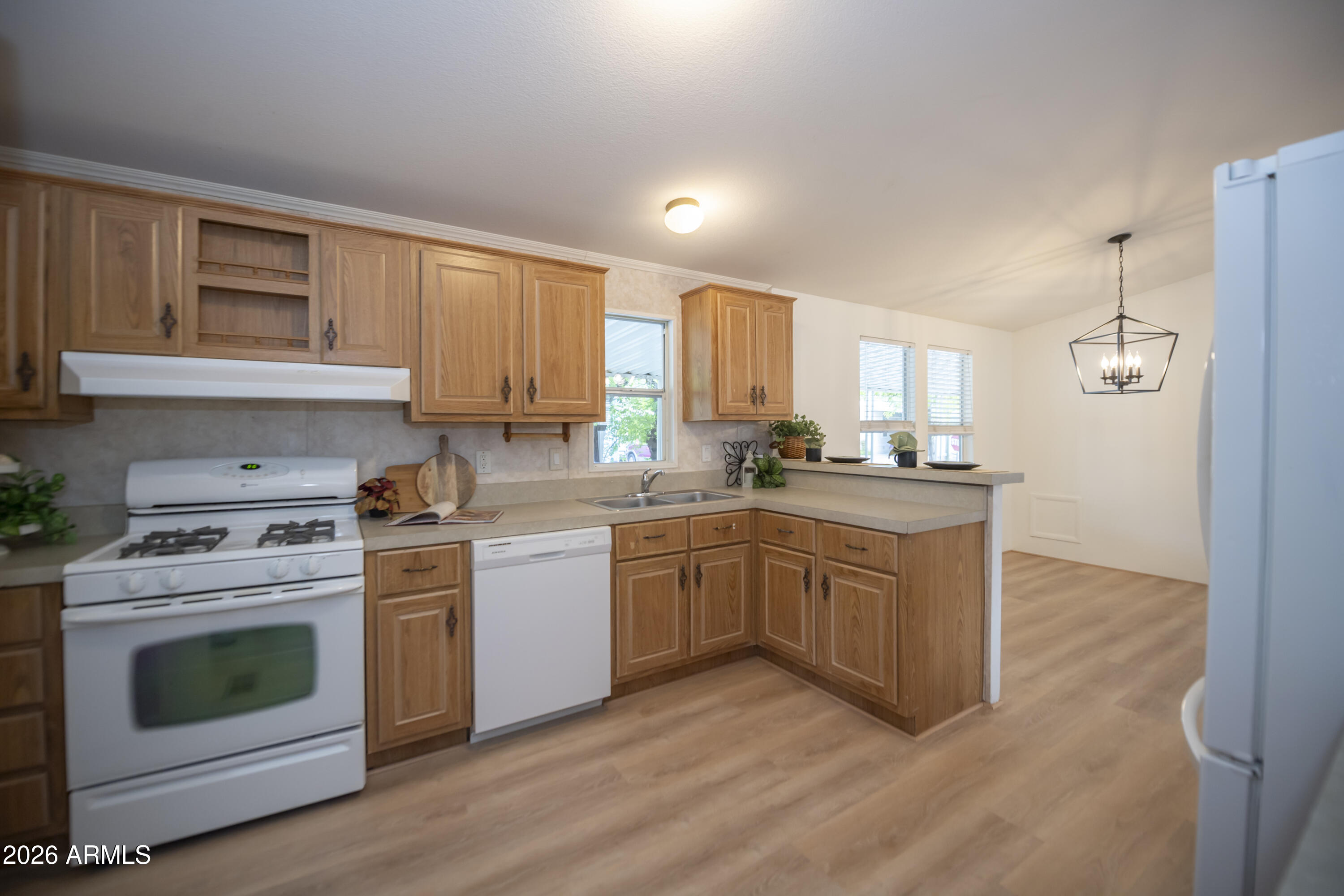 11250 East State Rte 69, Unit 1125 Dewey, AZ 86327 - Photo 12 of 45 a kitchen with a stove a sink and a refrigerator