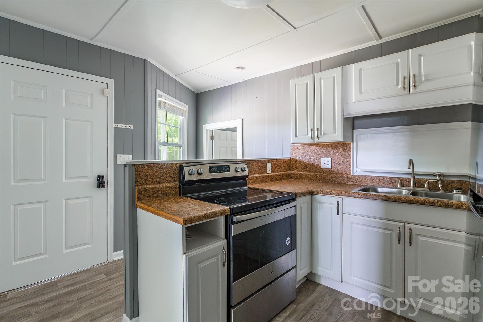 2823 Lyndell Way Lancaster, SC 29720 - Photo 5 of 19 a kitchen with a stove sink and cabinets