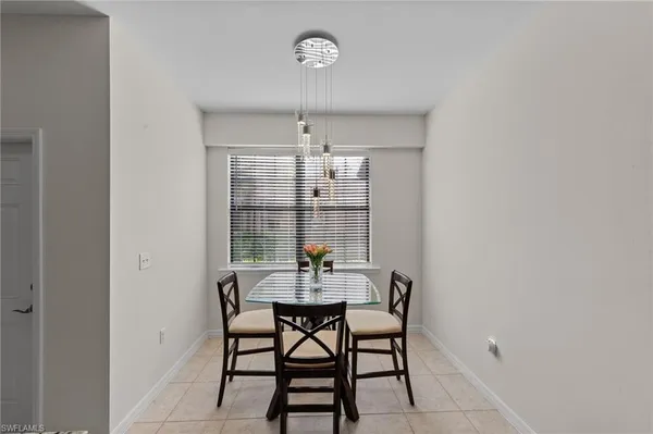 a dining room with furniture and chandelier