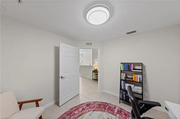 a view of a bedroom with a bookshelf