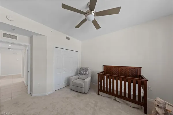 a bedroom with a bed and a ceiling fan