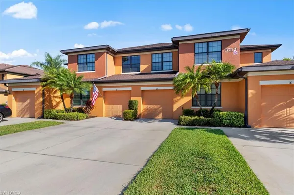 a front view of a house with a yard and a garage