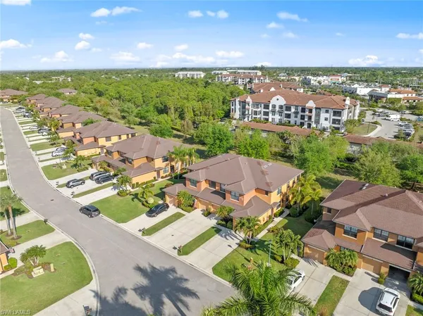 an aerial view of residential houses with outdoor space