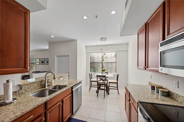a kitchen with granite countertop a sink and cabinets