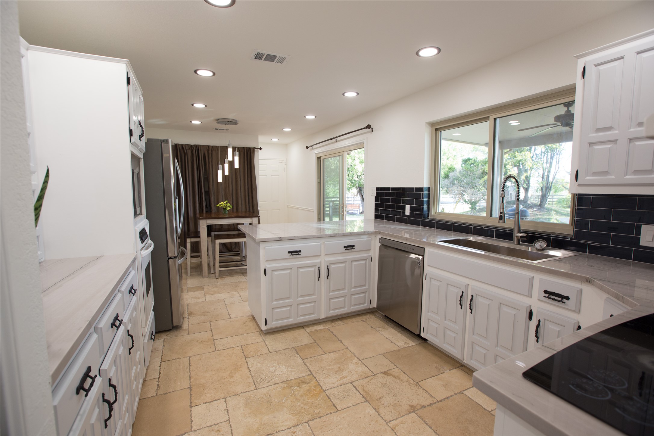 3517 Gattis School Road Round Rock, TX 78664 - Photo 3 of 16 A well-lit kitchen with sleek stainless steel appliances and a spacious island for culinary creations.