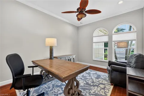 an empty room with a window and a ceiling fan