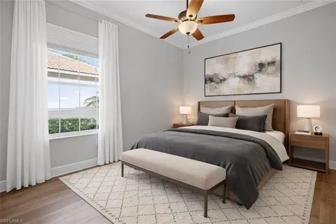 an empty room with a window and a ceiling fan