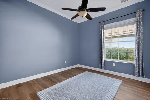a living room with furniture gym equipment and a window