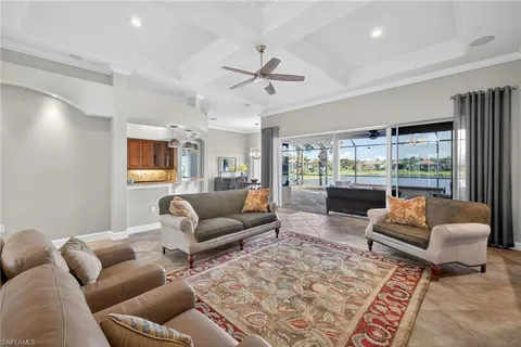 a living room with furniture and a view of kitchen