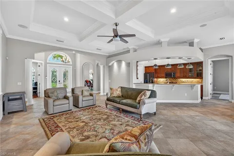 a view of a dining room with furniture a chandelier and wooden floor
